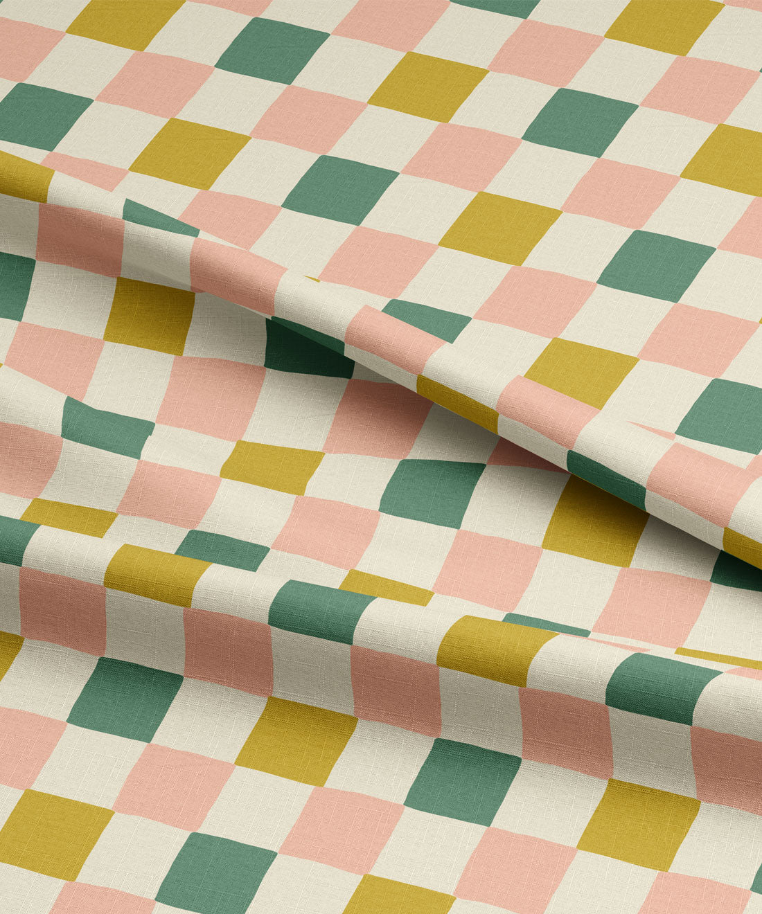 Checkered fabric with green, pink, and yellow squares on a white background