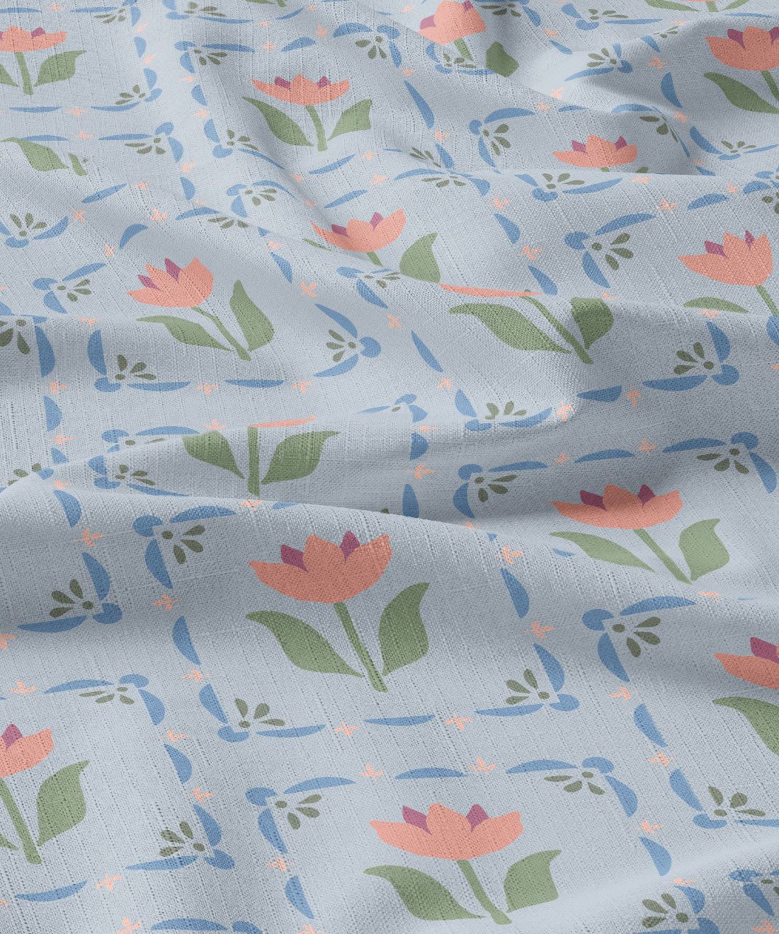 Floral patterned fabric with pink flowers and green leaves on a light blue background