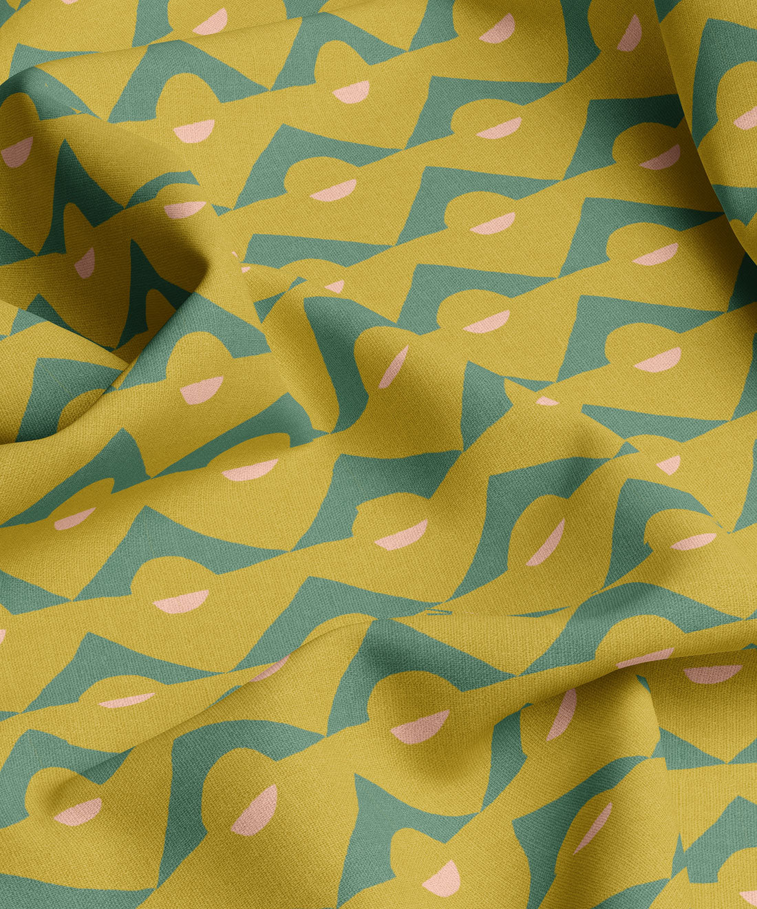 Fabric with a yellow and green pattern featuring abstract shapes and pink accents.
