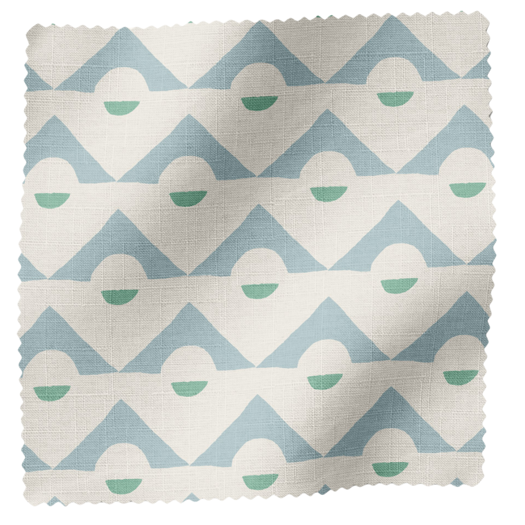 Fabric swatch with a pattern of blue and white triangles and green circles.