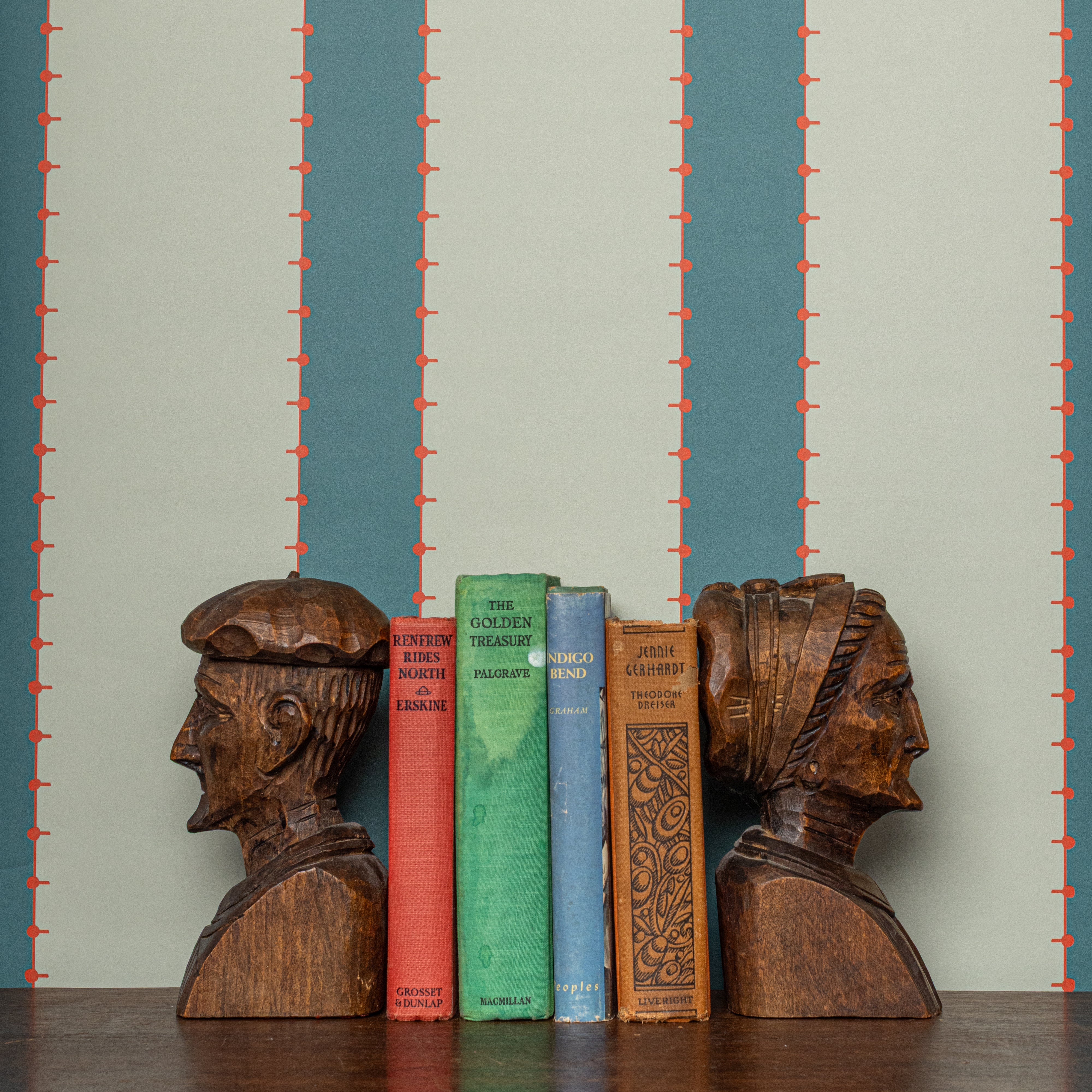 A striped wallpaper in peacock blue and hints of red