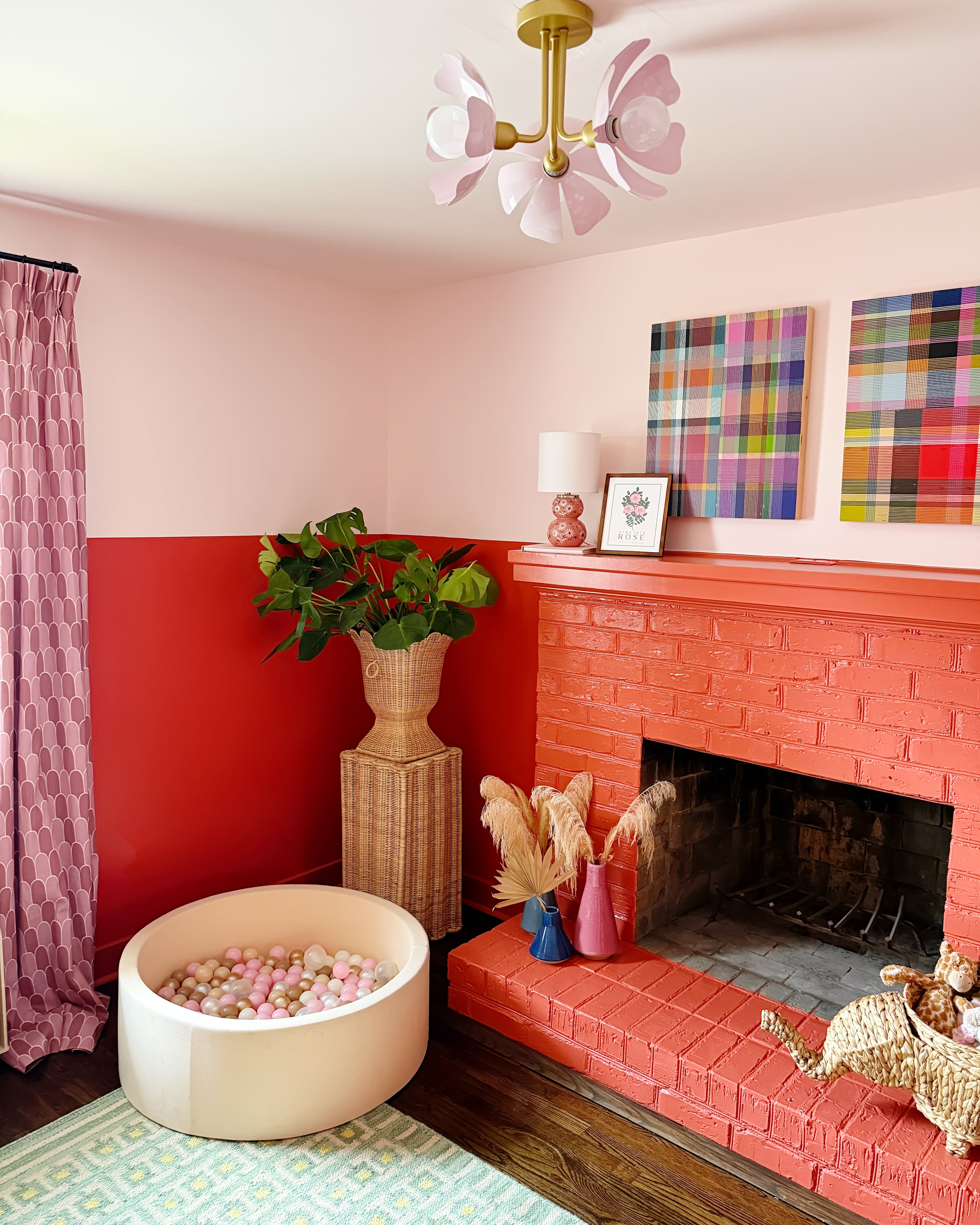 play room with a red fireplace, pink walls, and decorative elements.