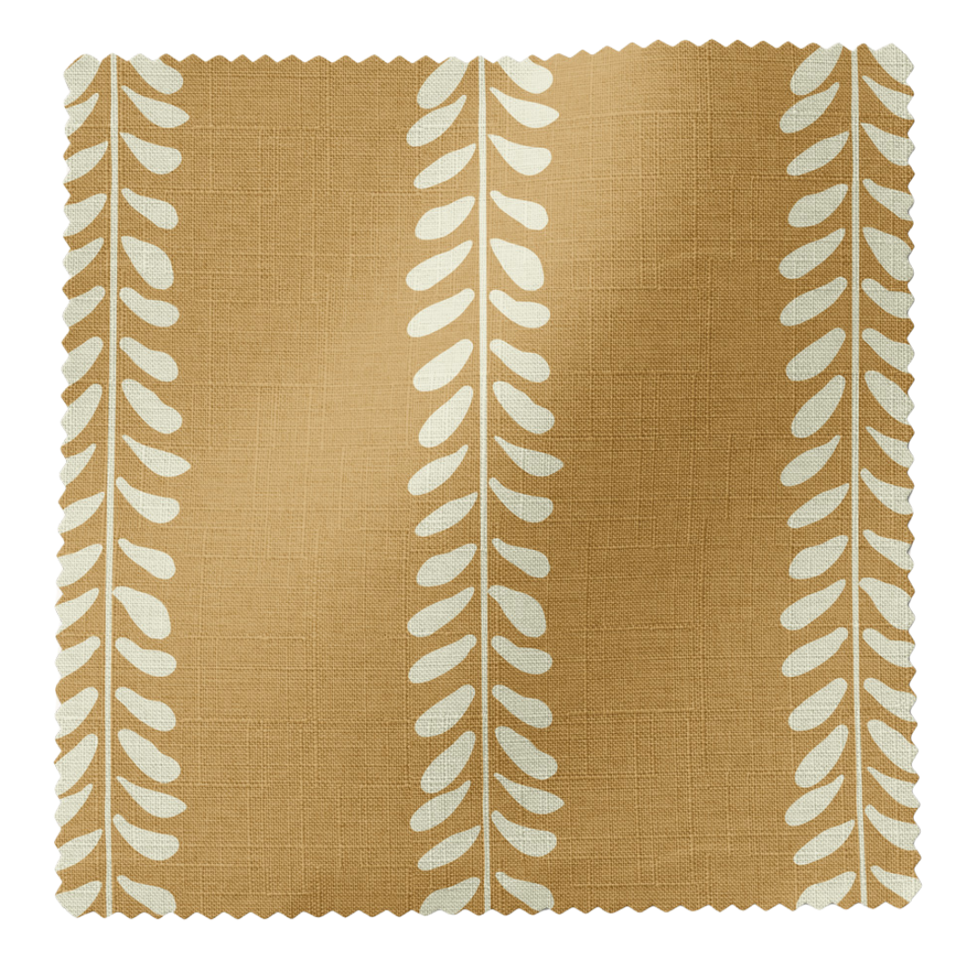 Textile sample with white leaf pattern on a mustard background