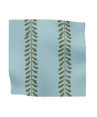 Fabric sample with leaf pattern on a light blue background