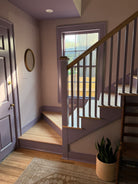Purple Staircase with window and wallpapered walls 