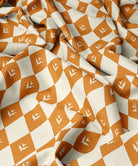 Fabric with floral orange and white diamond pattern
