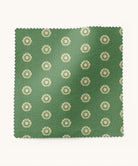 Green fabric swatch with beige floral pattern