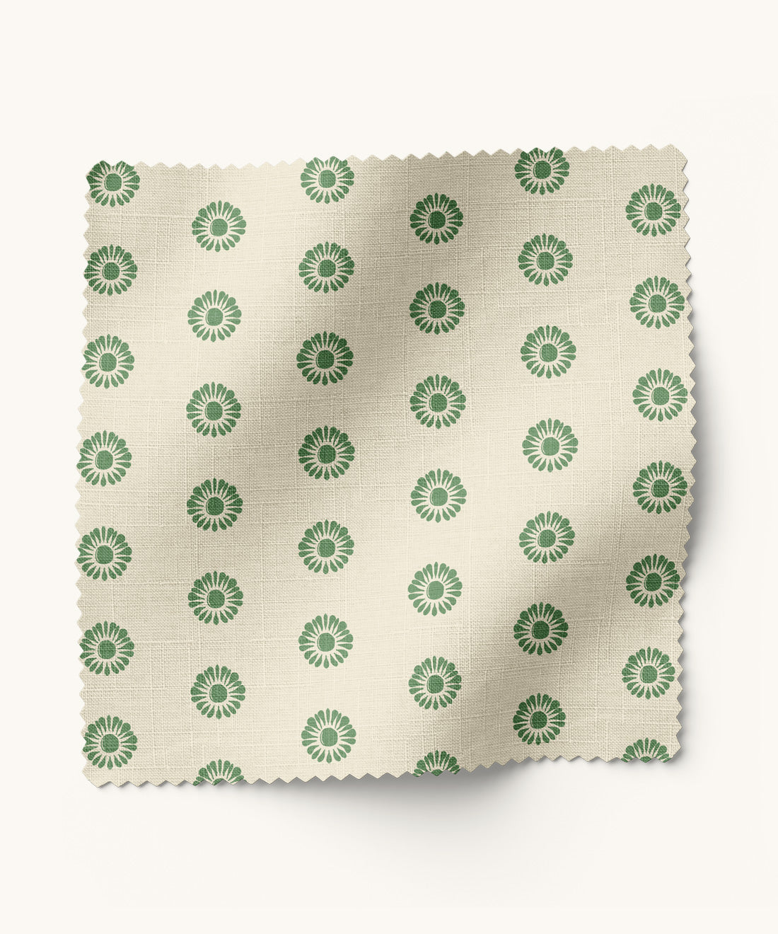 Fabric swatch with green floral pattern on a beige background