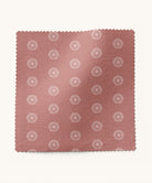 Fabric swatch with a floral pattern on a pink background