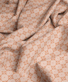 Geometric patterned fabric in peach and orange by Gray Benko Home
