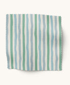 Striped fabric sample with green, blue, and white stripes on a white background