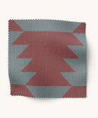 Fabric swatch with geometric pattern  in burgundy and blue on a white background