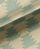 Patterned fabric with geometric design in green and beige tones