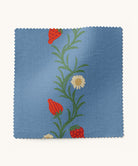 fabric sample with a strawberry and floral design on a blue background