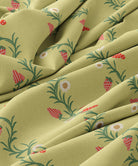 Close-up of green fabric with floral and strawberry pattern