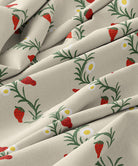 Fabric with strawberry and daisy pattern on a beige background