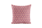Decorative pillow with pink geometric pattern on a white background