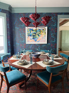 Blue trim in dining room with blue and maroon wallpaper.