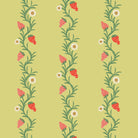 A roll of wallpaper with a repeating pattern of strawberries and green leaves on a chartreuse background.