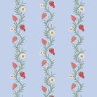 A roll of wallpaper with a floral pattern featuring strawberries and leaves on a periwinkle blue background.