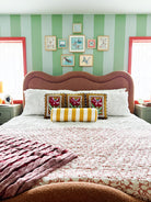 Striped green bedroom with red paint trim 