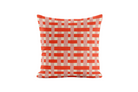 Decorative pillow with red and white geometric pattern on a white background